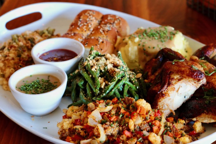 A Thanksgiving plate from Lunchboxx featuring chicken, green beans, cornbread chorizo stuffing and other dishes