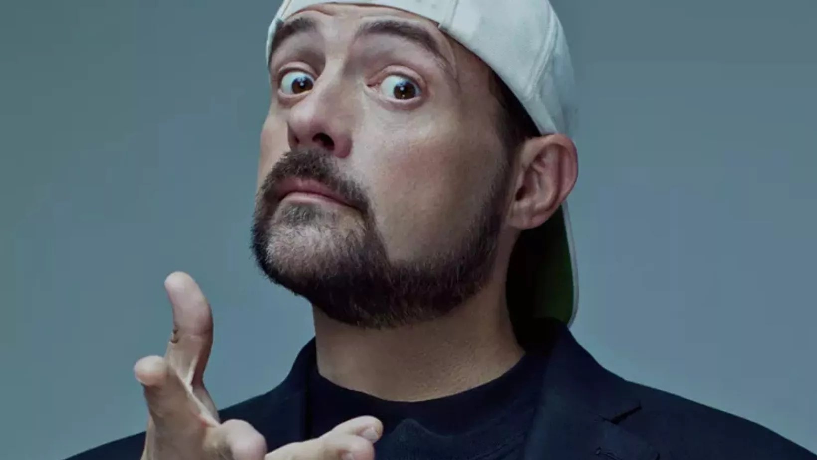 photo of Kevin Smith posing in a white hat and black t-shirt