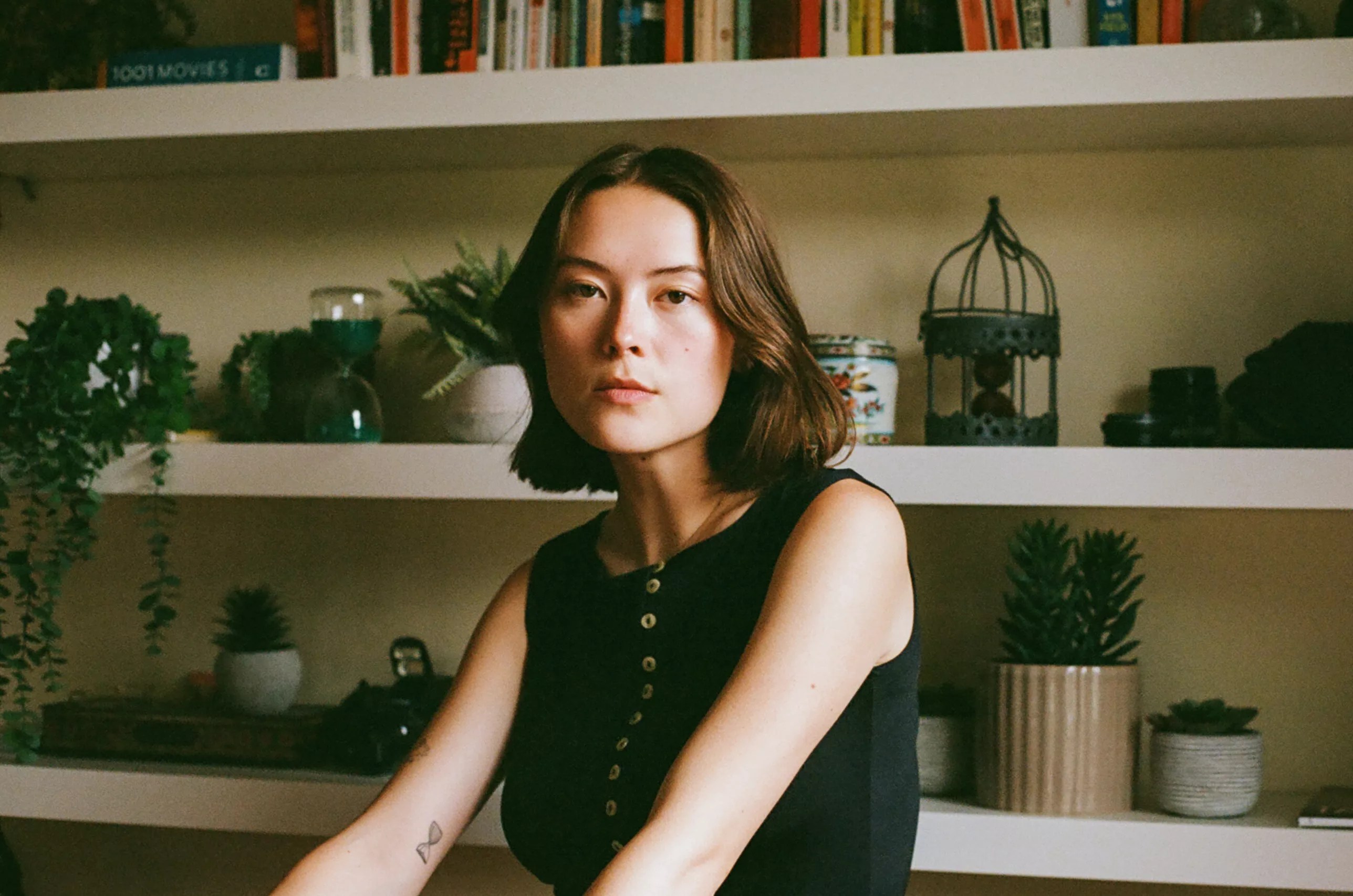 woman sitting in front of shelf