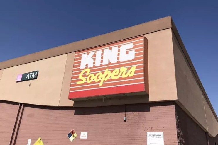 The brick exterior and large red retail sign at King Soopers in Denver