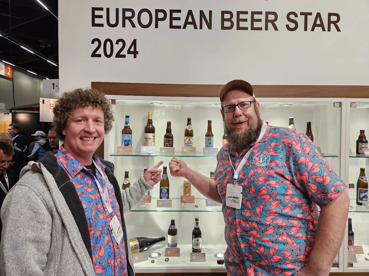 Two brewers sharing competition medals.