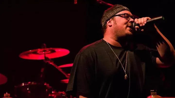 Raymond "Ray Bones" Salazar singing into a microphone