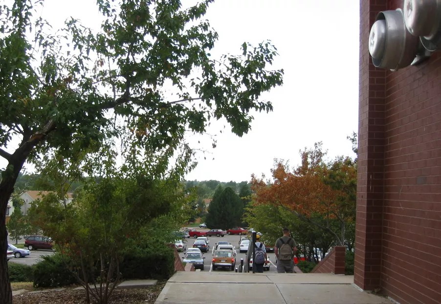 high school students walk down the stairs outside