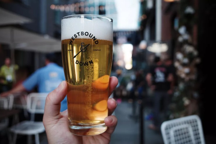 hand holding a pint of beer