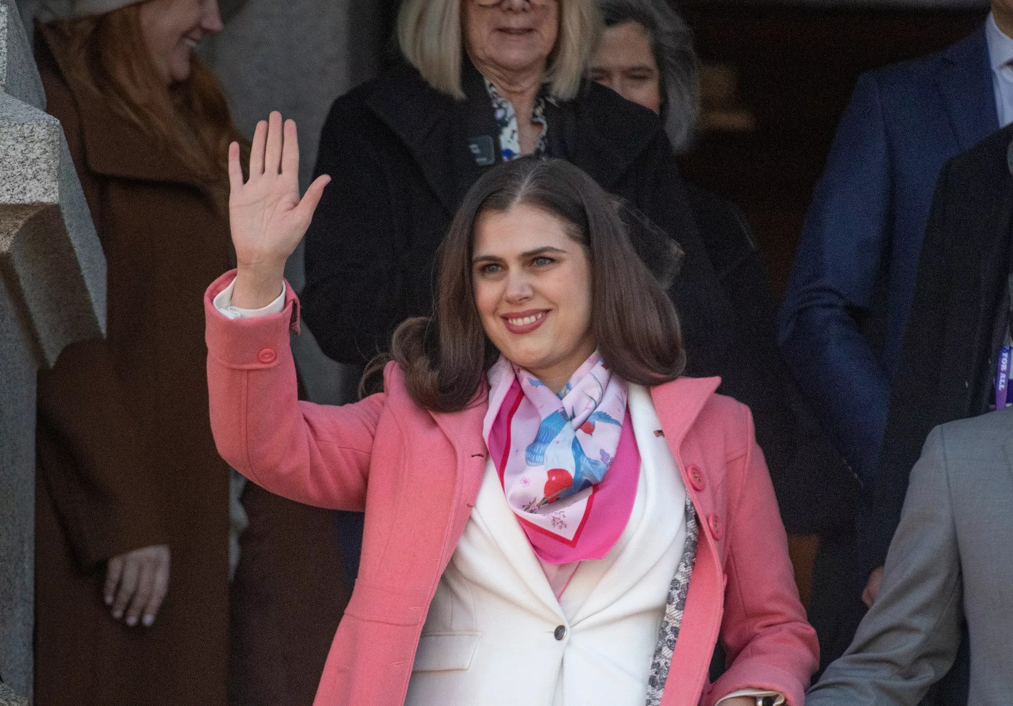 Woman waves at crowd
