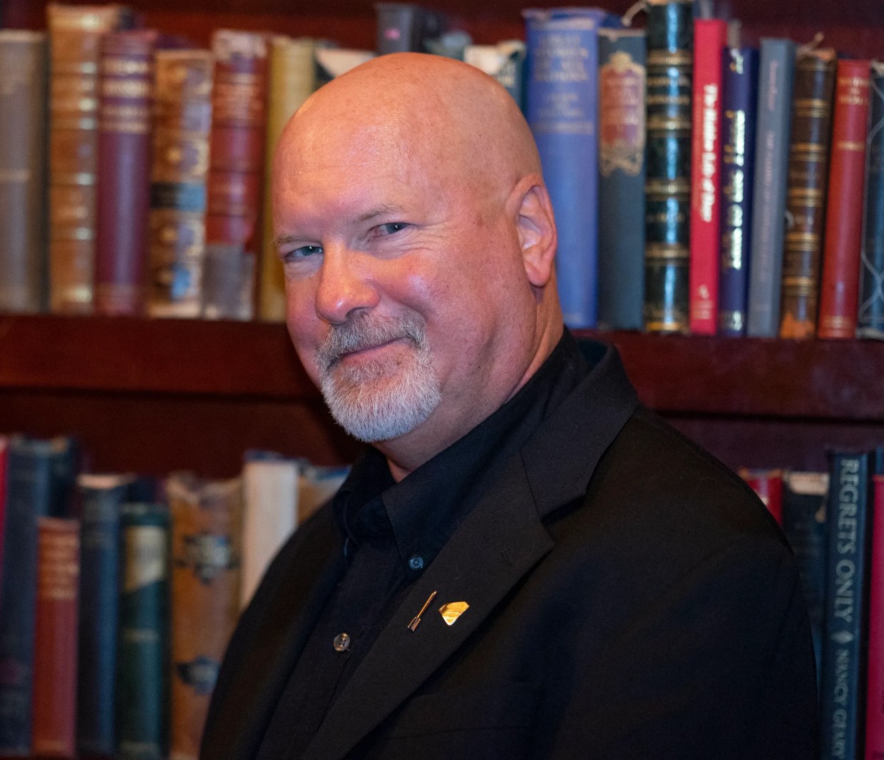 Kevin J. Anderson in front of a bookshelf