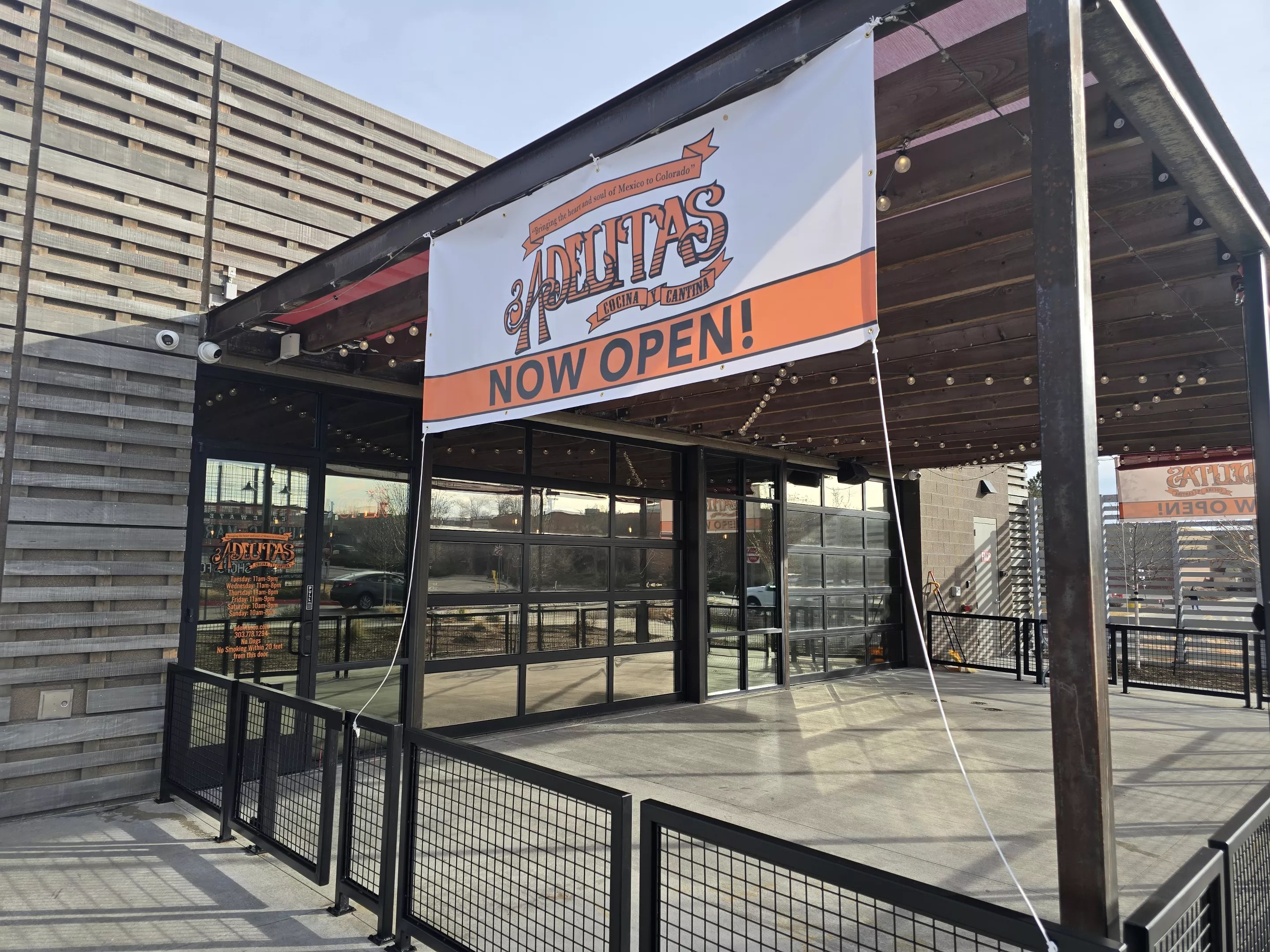 "now open" sign on a building