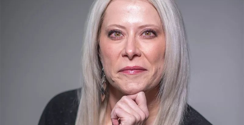 blonde woman looking at camera