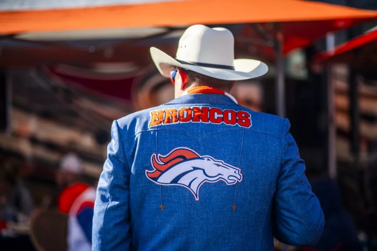 man in broncos cowboy hat and jacket.