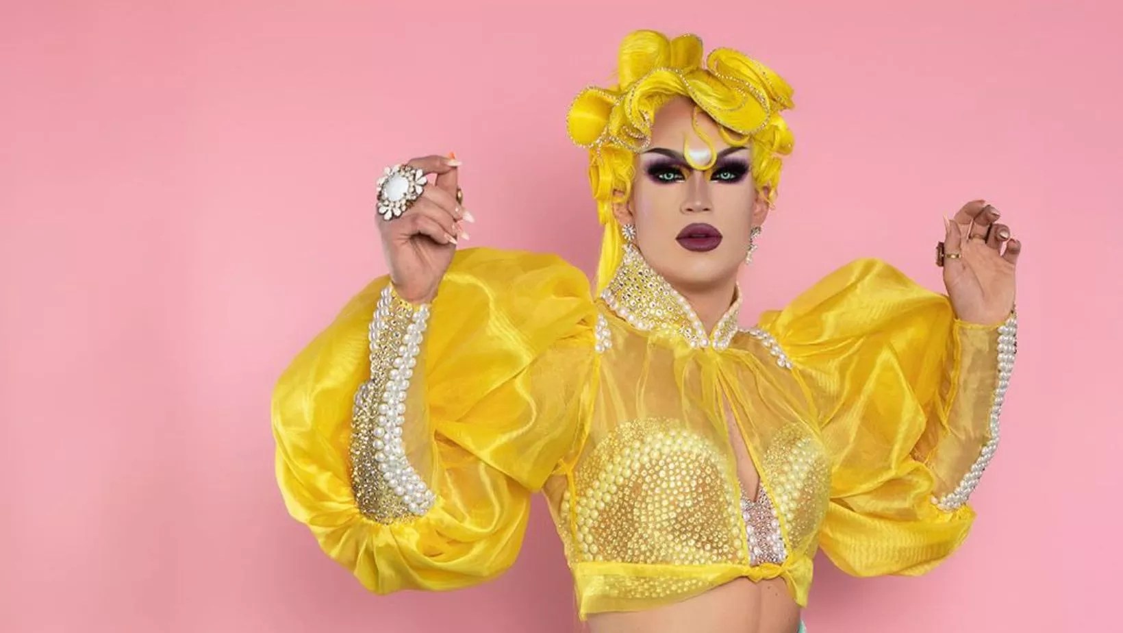 drag queen in gold top and wig