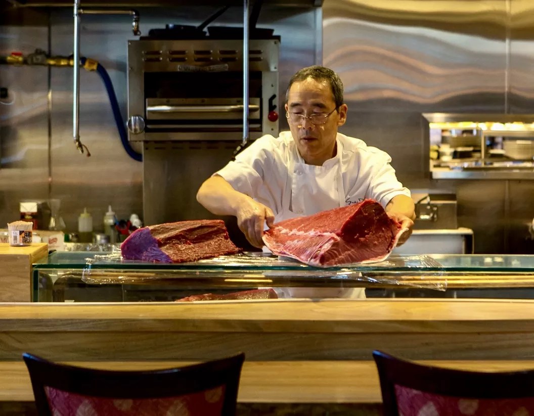 chef holding large piece of fish