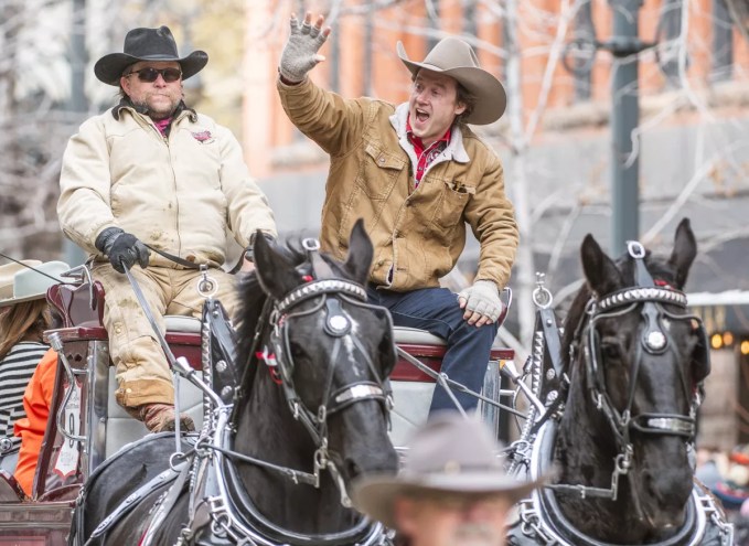 man waving in parade