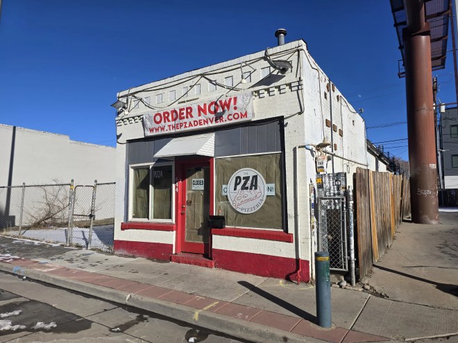 exterior of a small white and red building