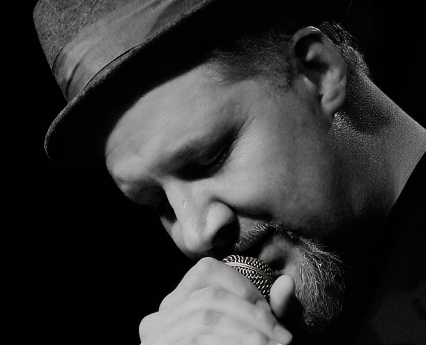 David Dinsmore singing into a microphone