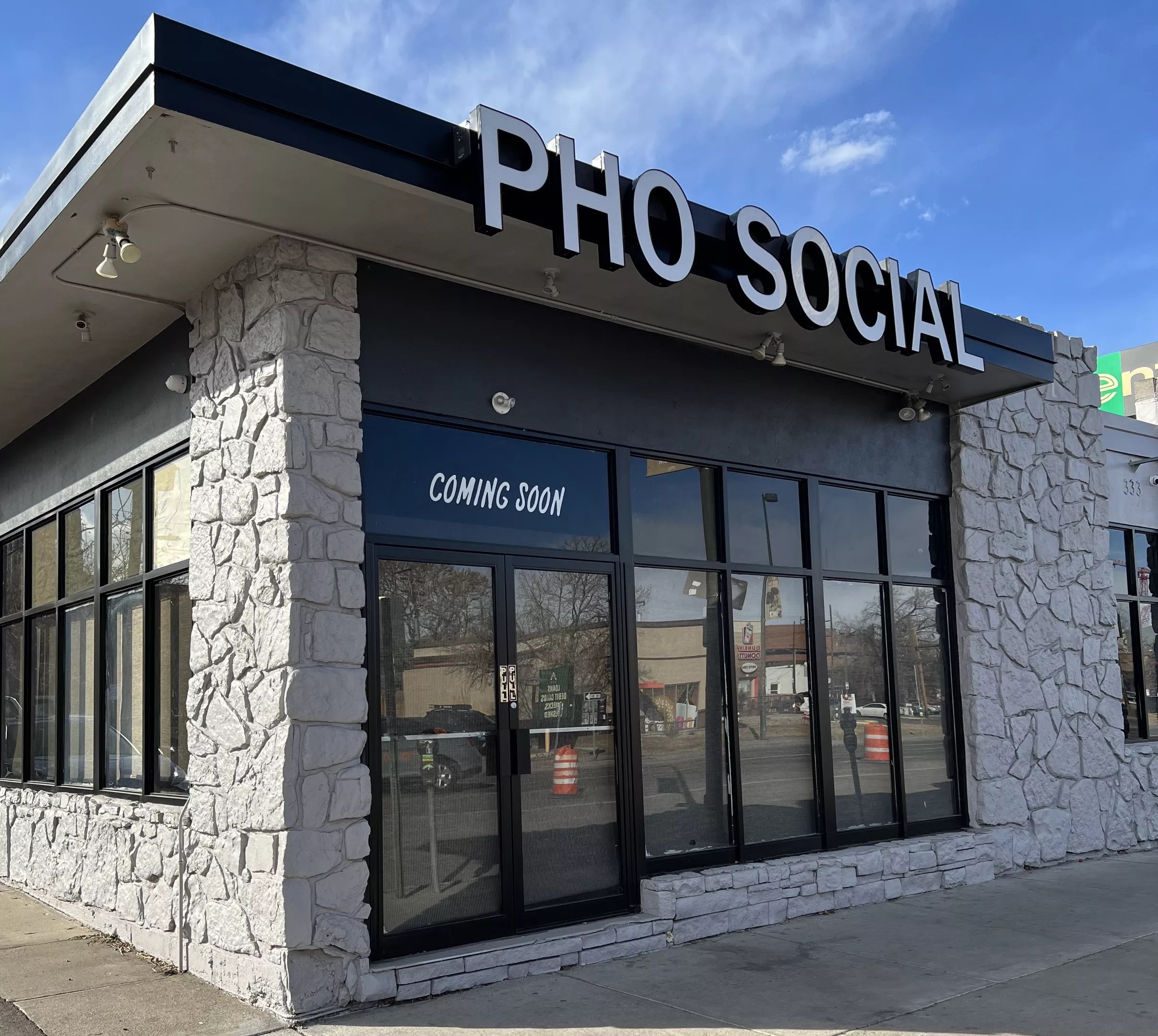 exterior of a building with a "pho social" sign