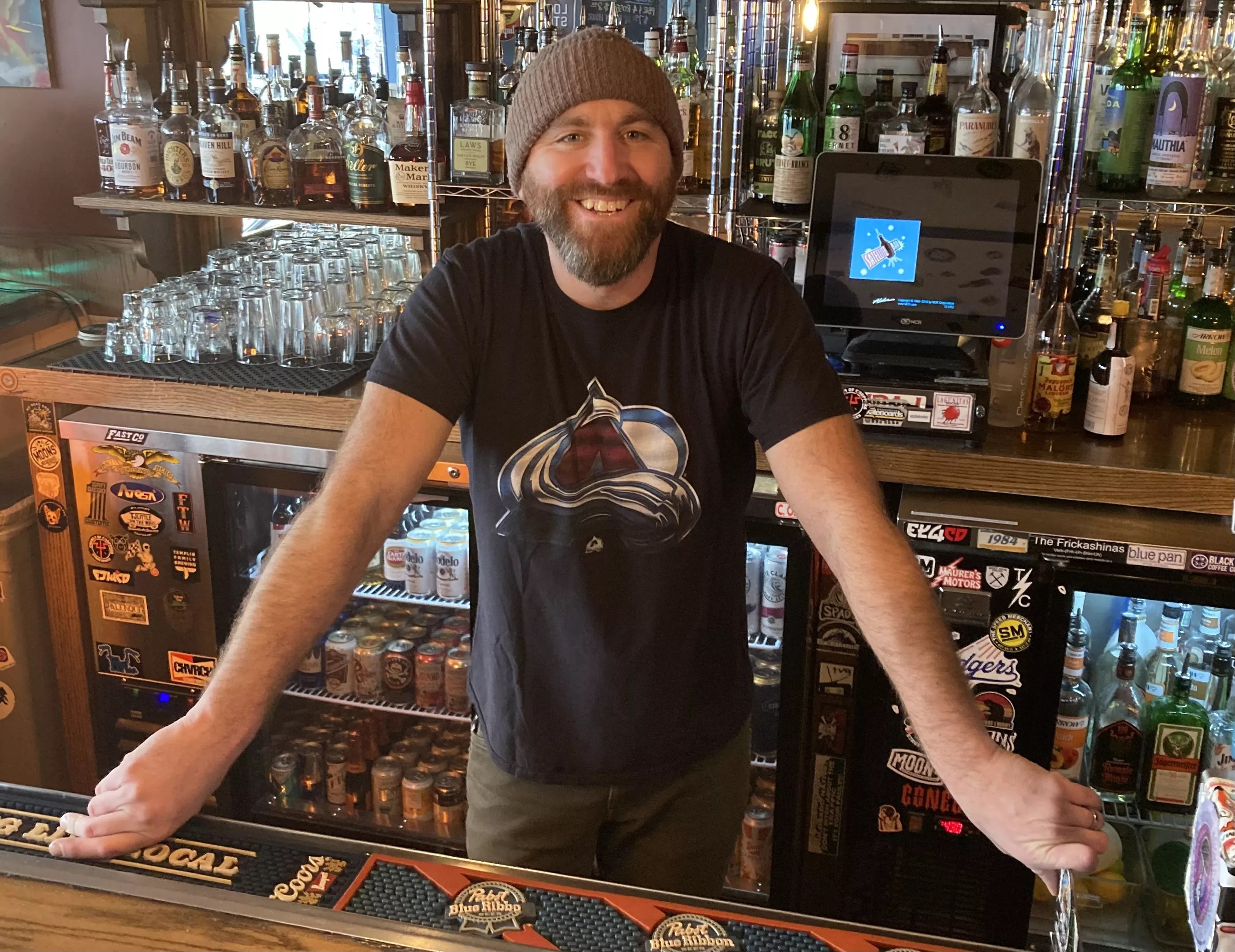 Michael John standing behind a bar.