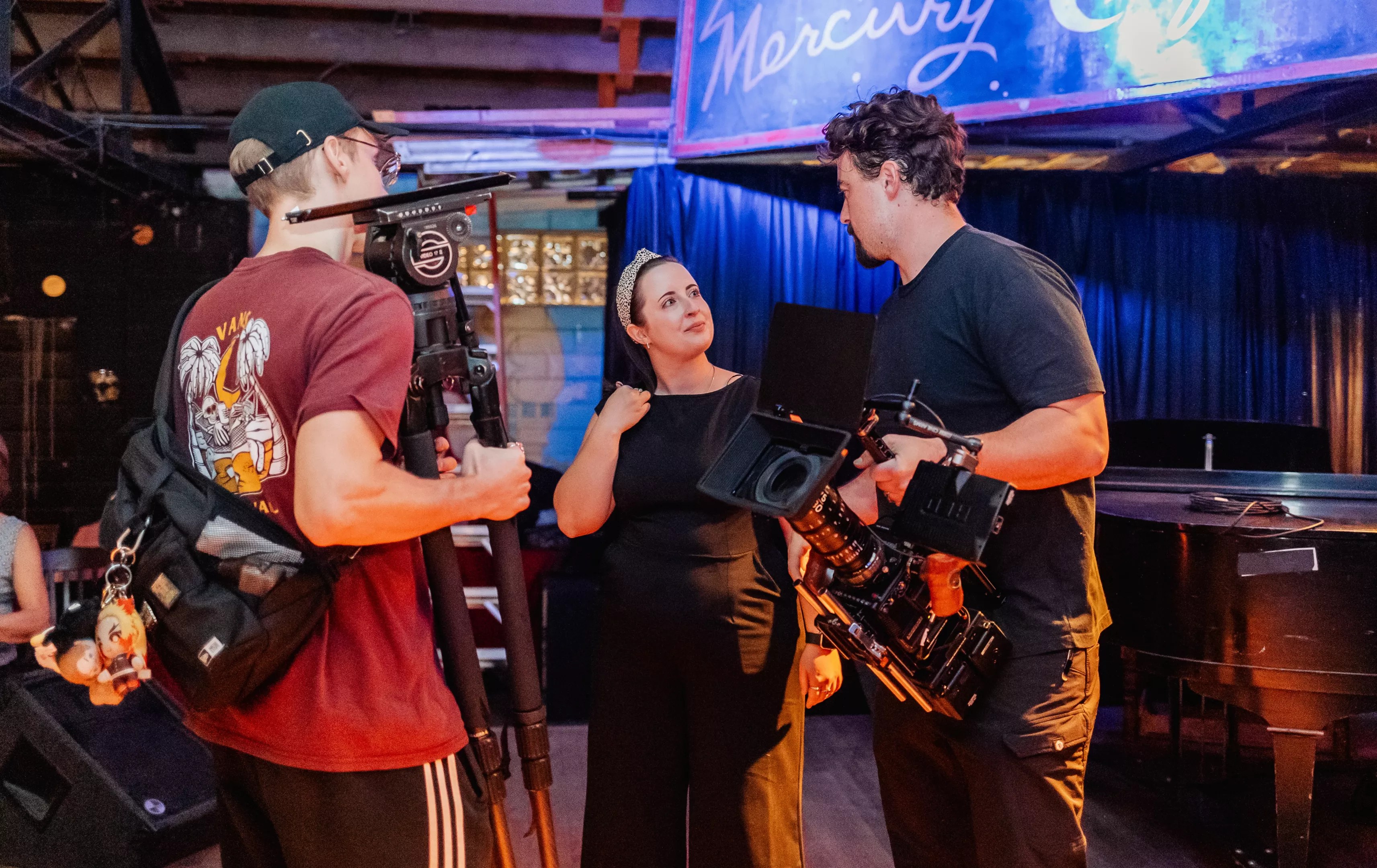 Three filmmakers standing in a room
