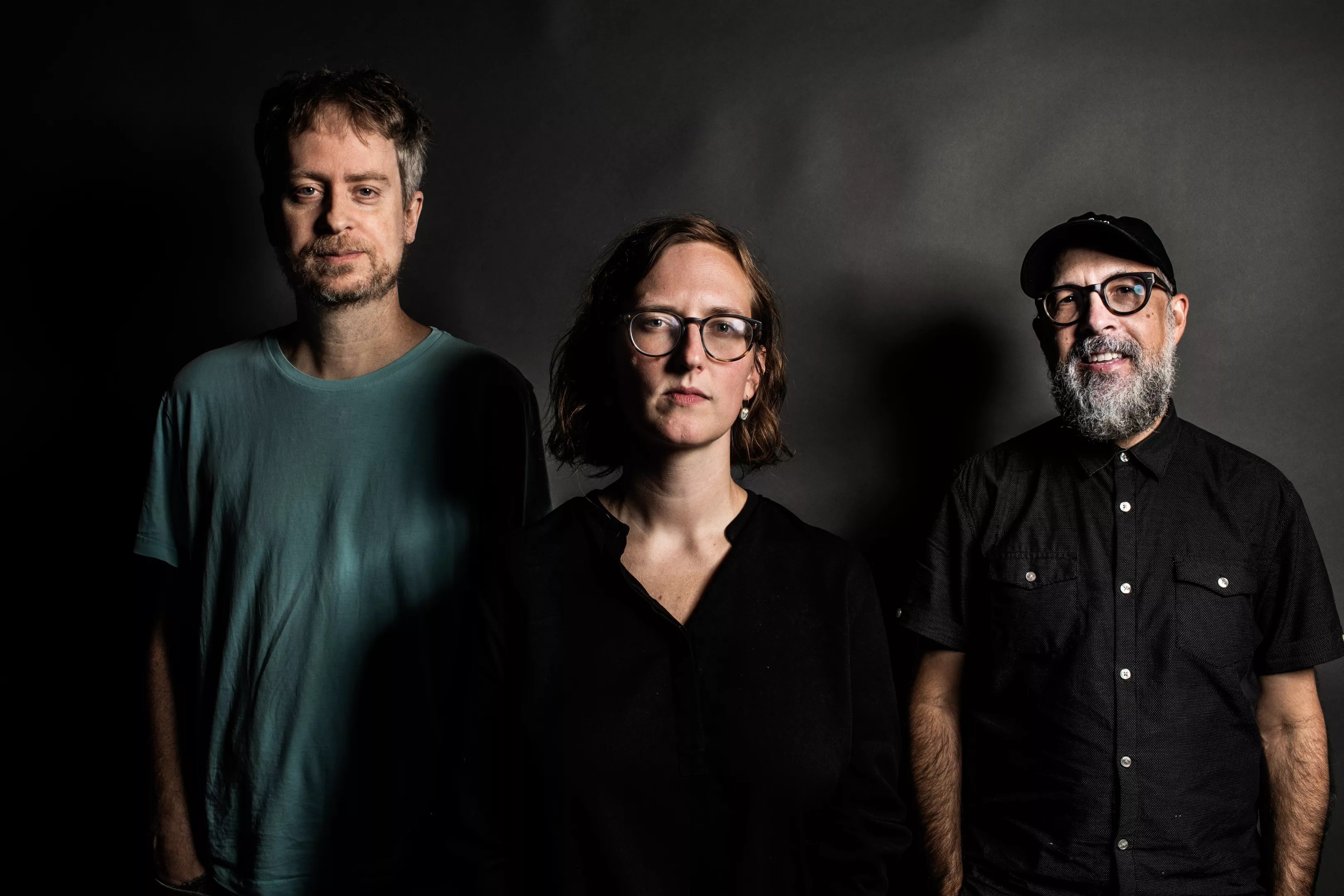 three people in front of screen