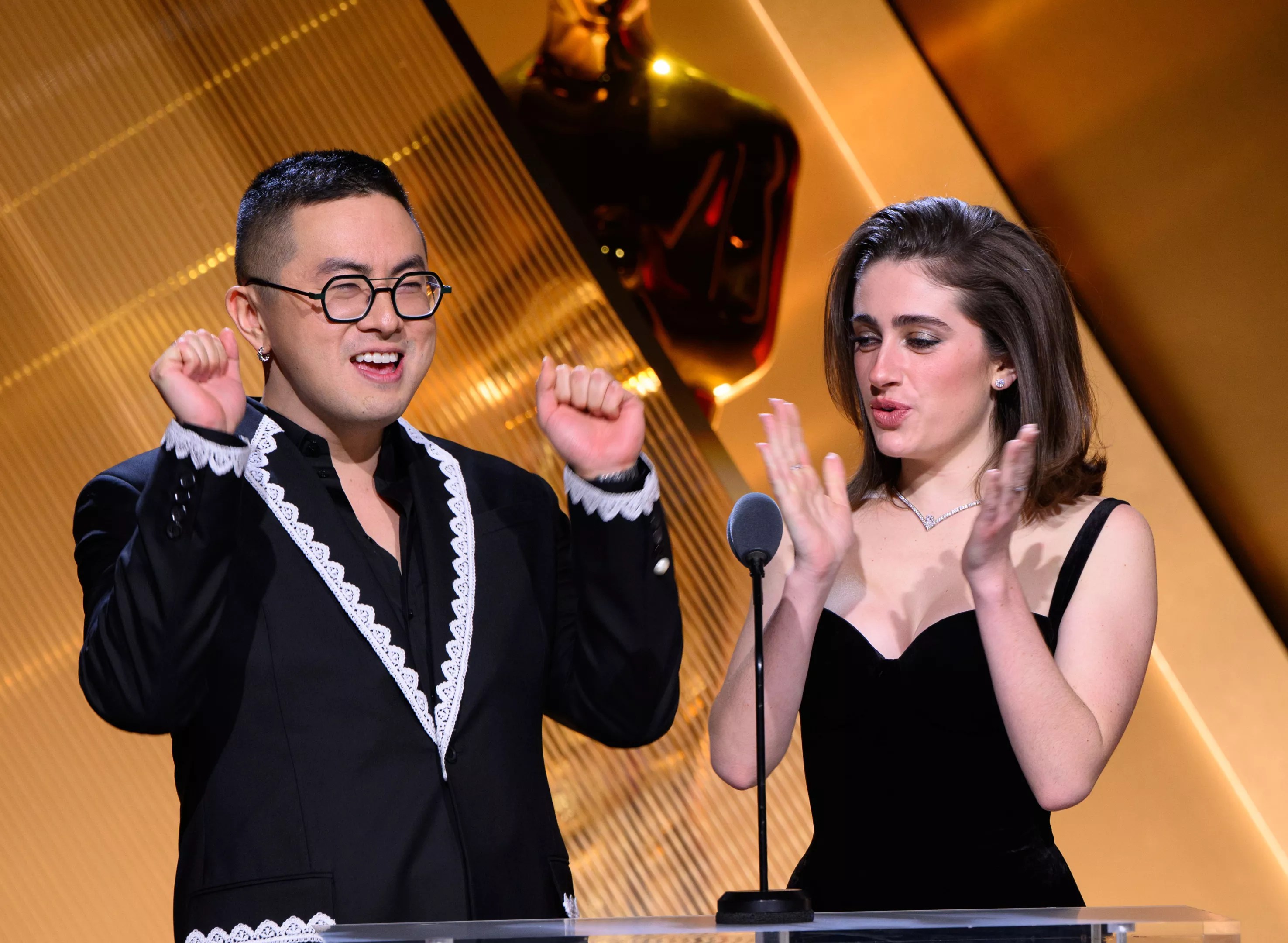 man and woman announcing awards