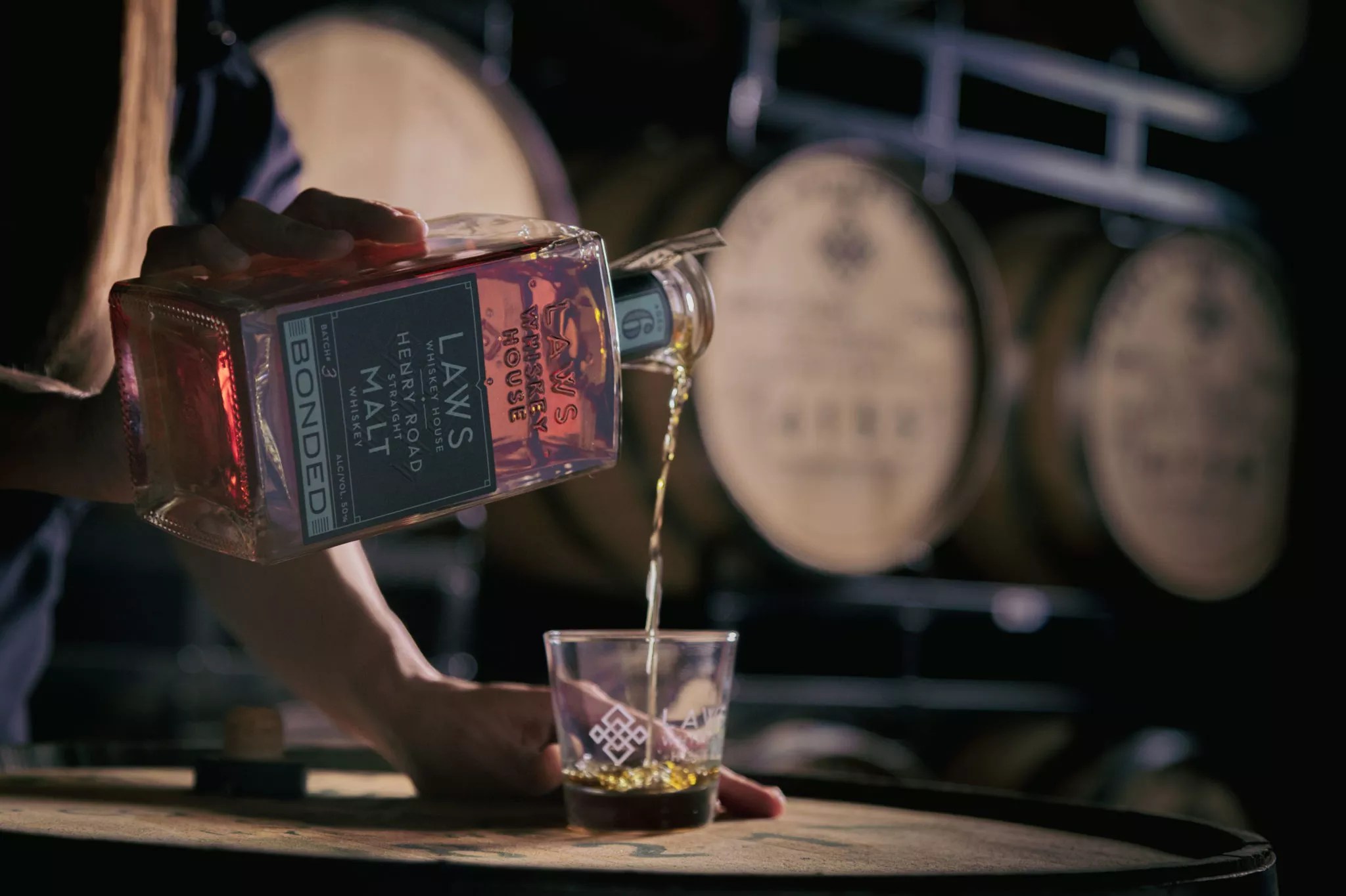 whiskey being poured into a glass from a bottle