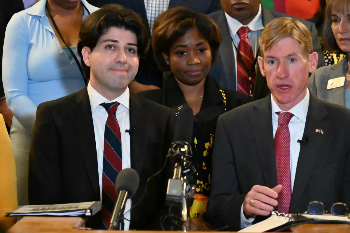 Two people speak at the Capitol.