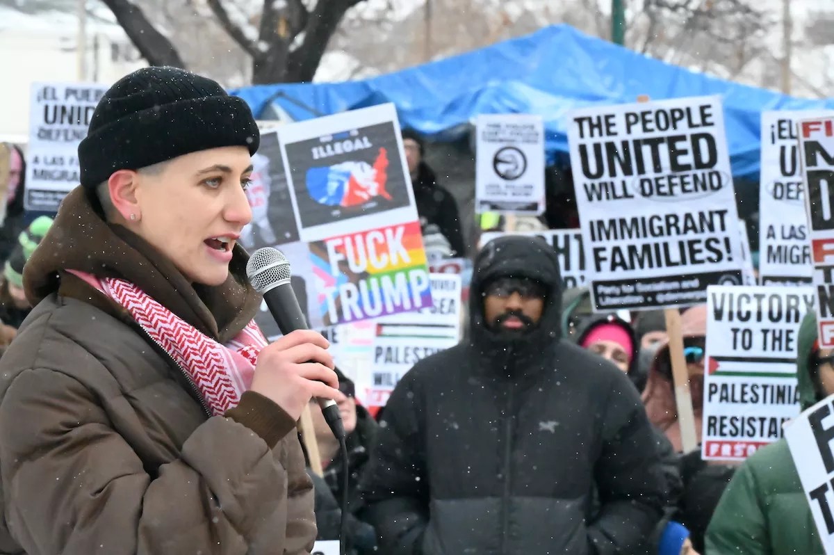 A person speaks in the snow.