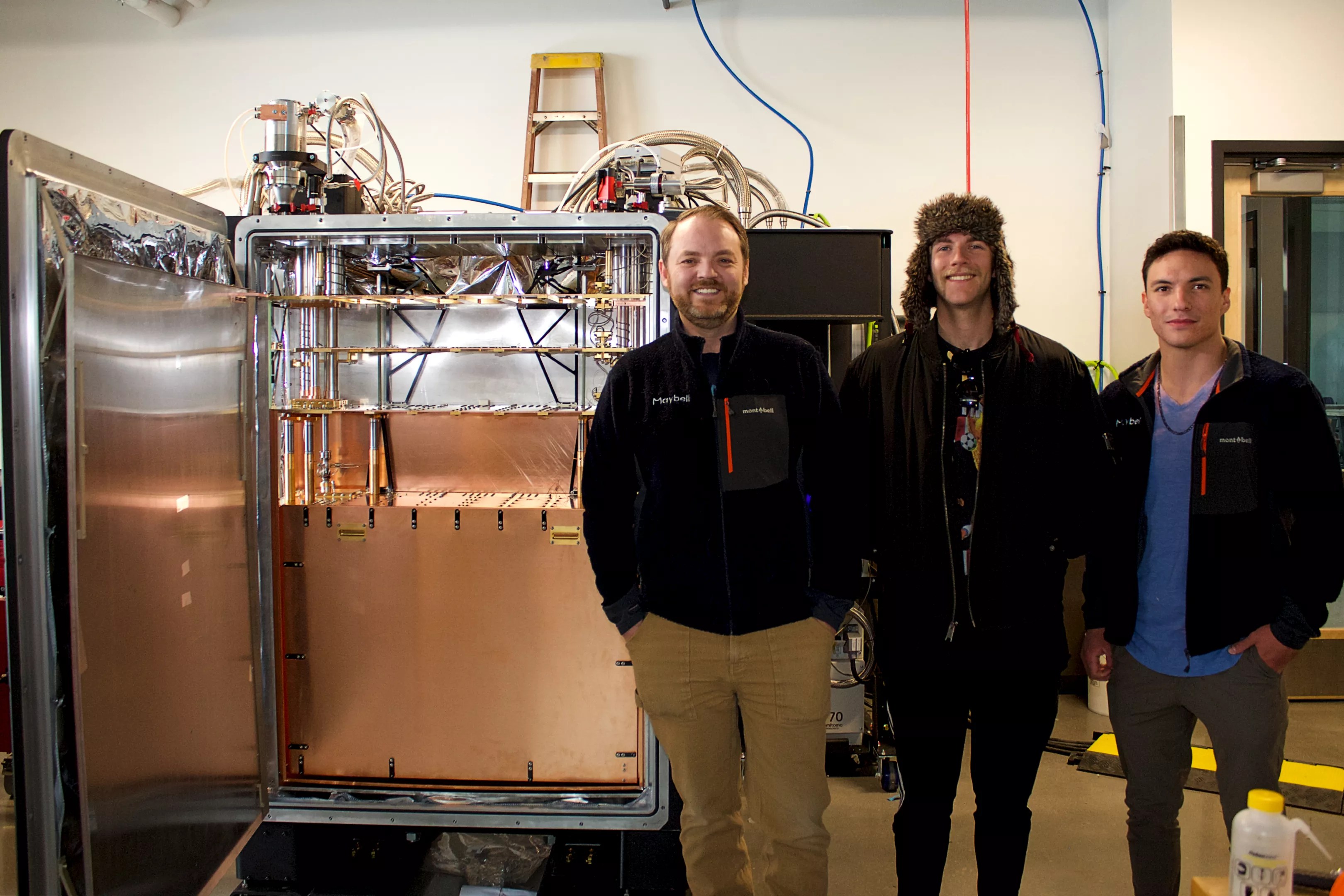 Men stand in front of quantum fridge