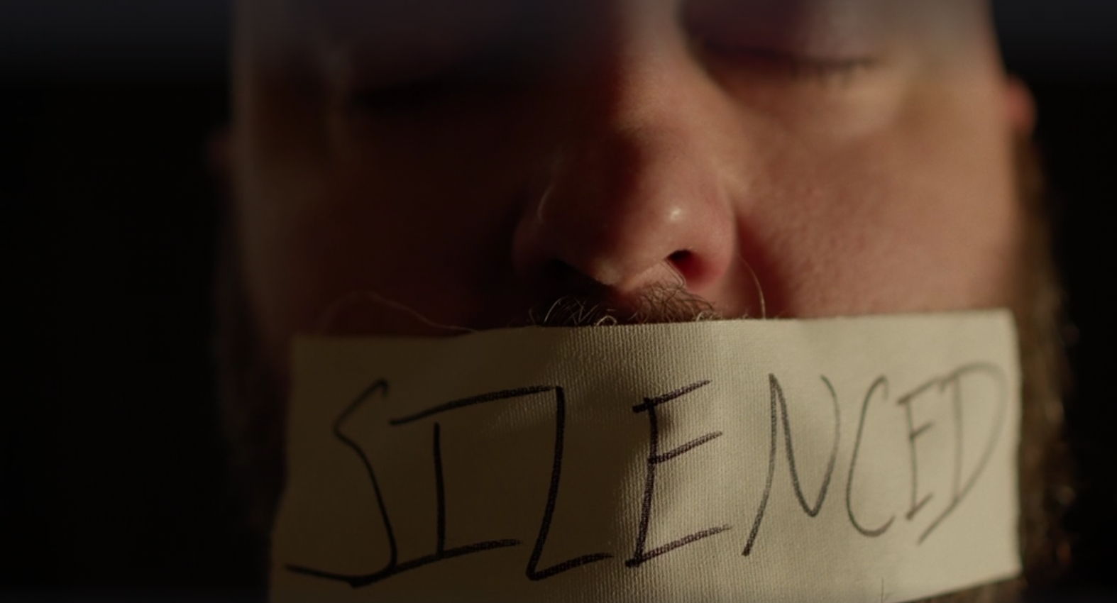 man with duct tape over his mouth