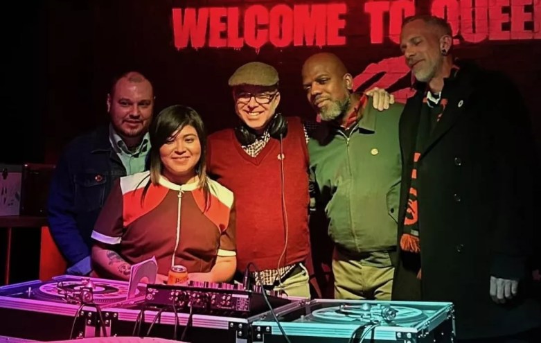 The five DJs of Denver Vintage Reggae Society standing behind turntables