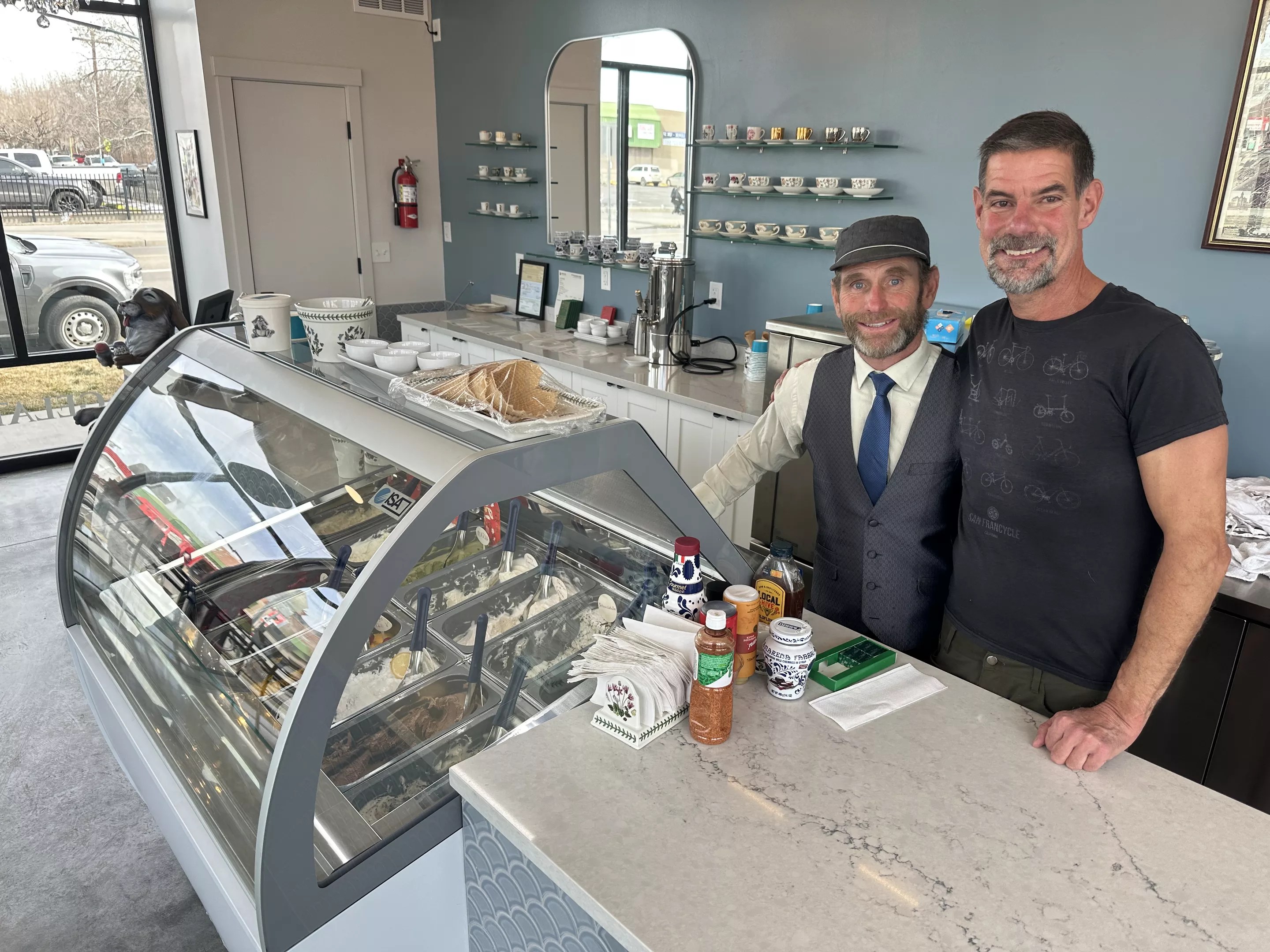 two men behind an ice cream shop counter