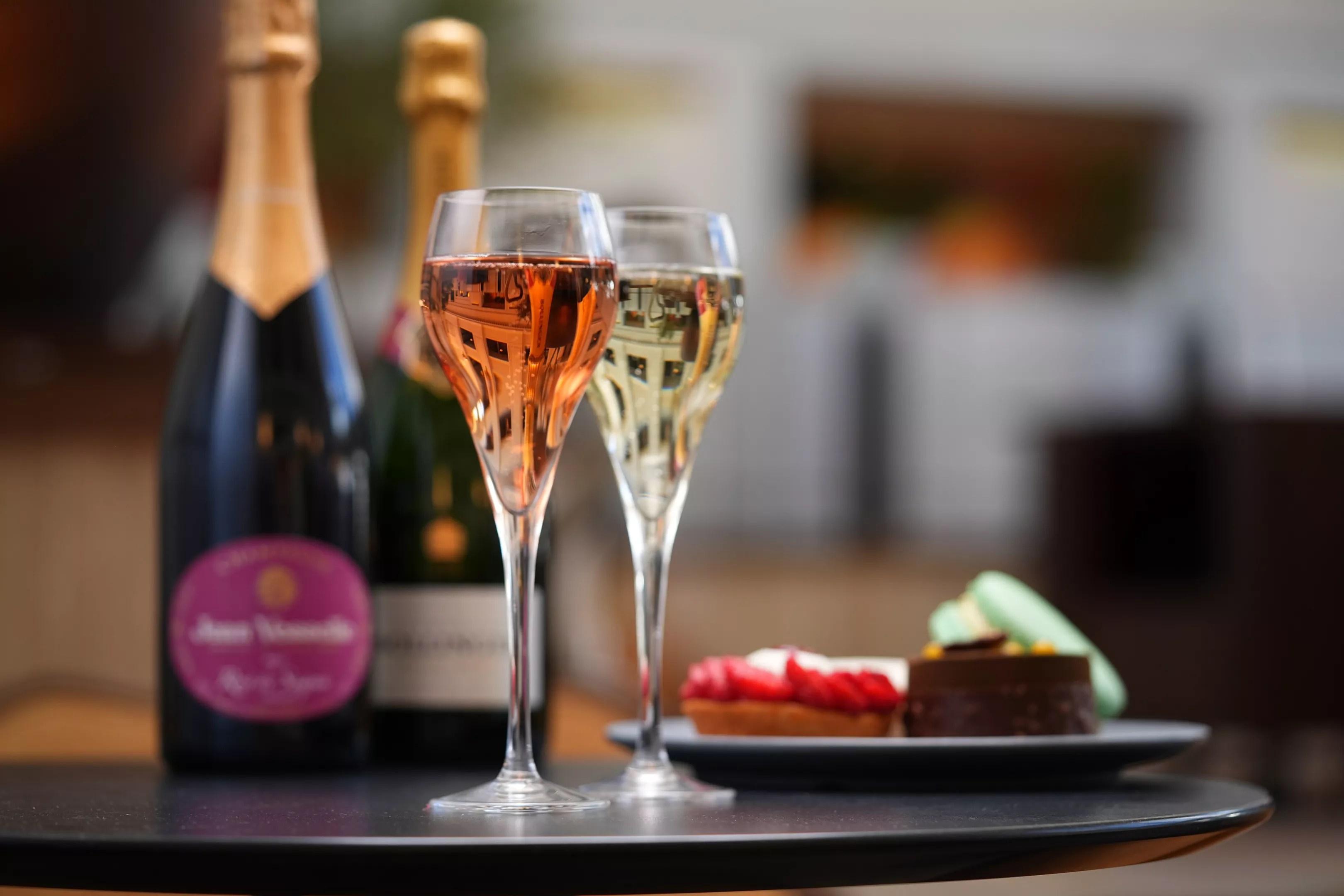 two glasses of champagne and pastries