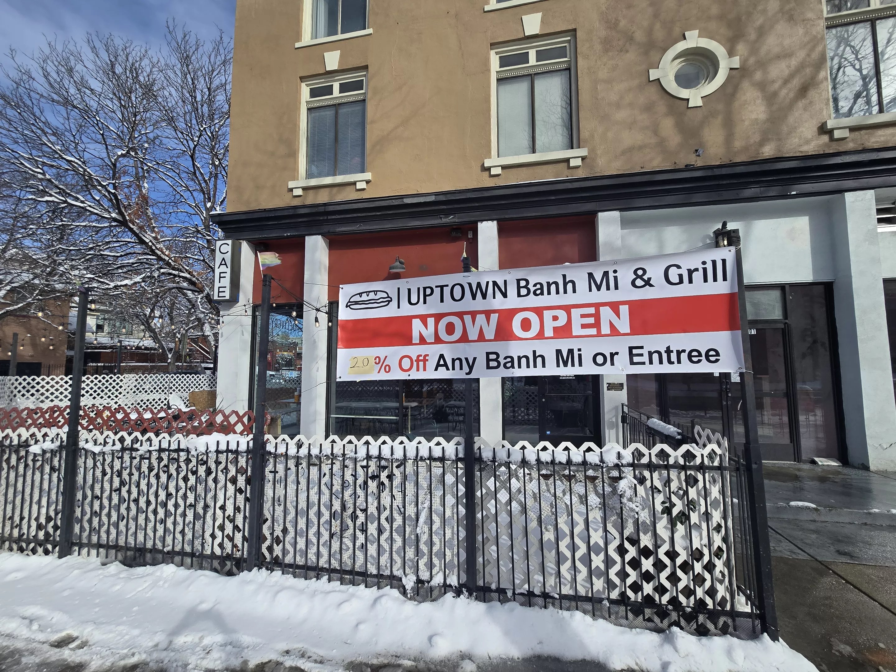 "now open" sign on a fance