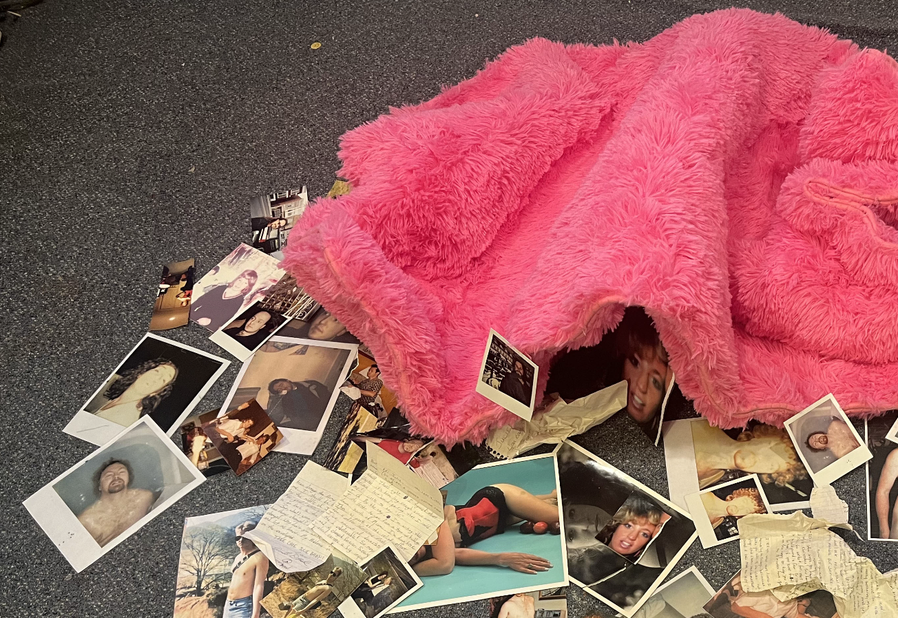 A pink shag rug surrounded by photos and letters