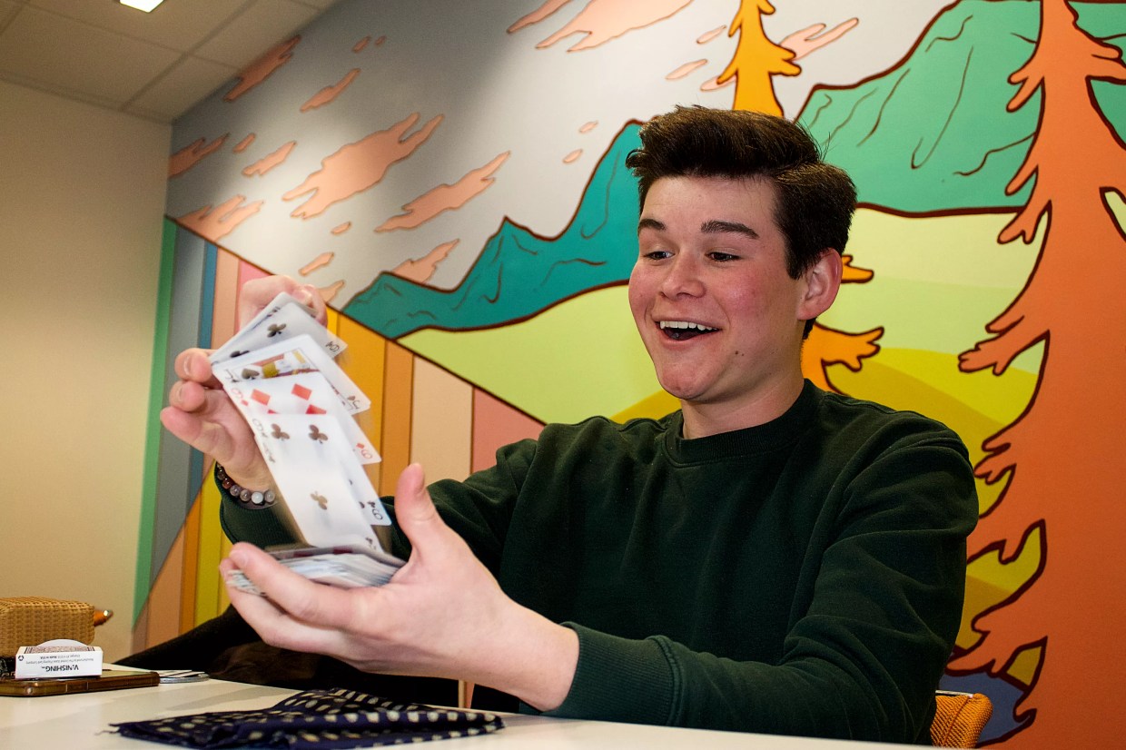 A boy flipping playing cards