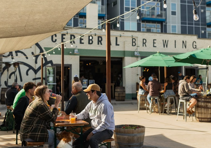 people sitting at tables on a patio