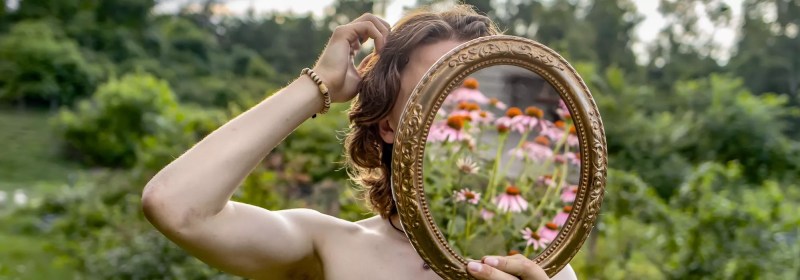 woman looking in mirror