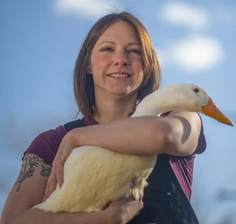Woman with duck against blue sky