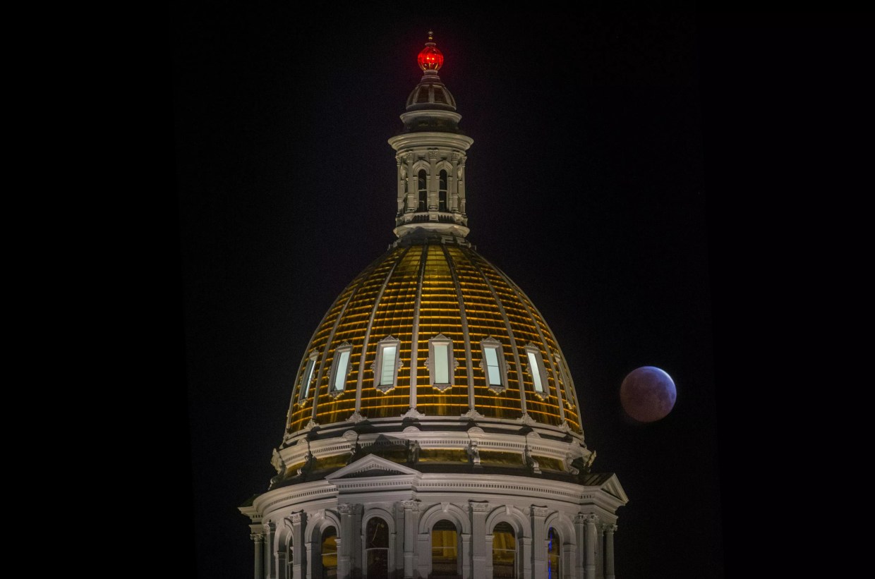 Red moon behind Colorado State Capitol dome