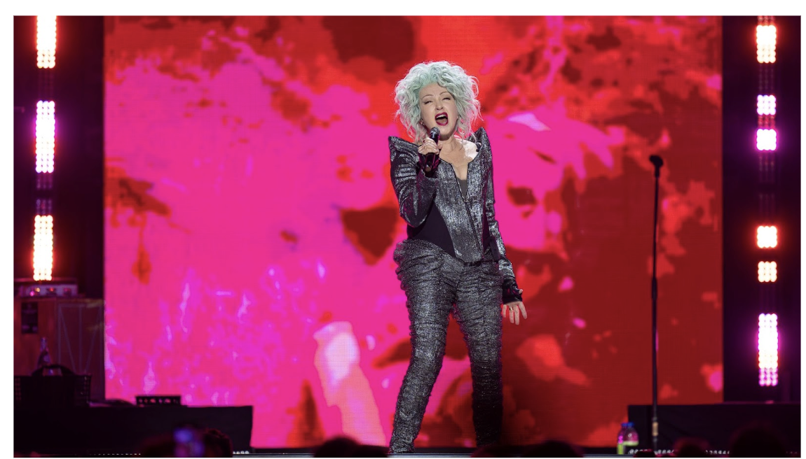 Cyndi Lauper singing on stage