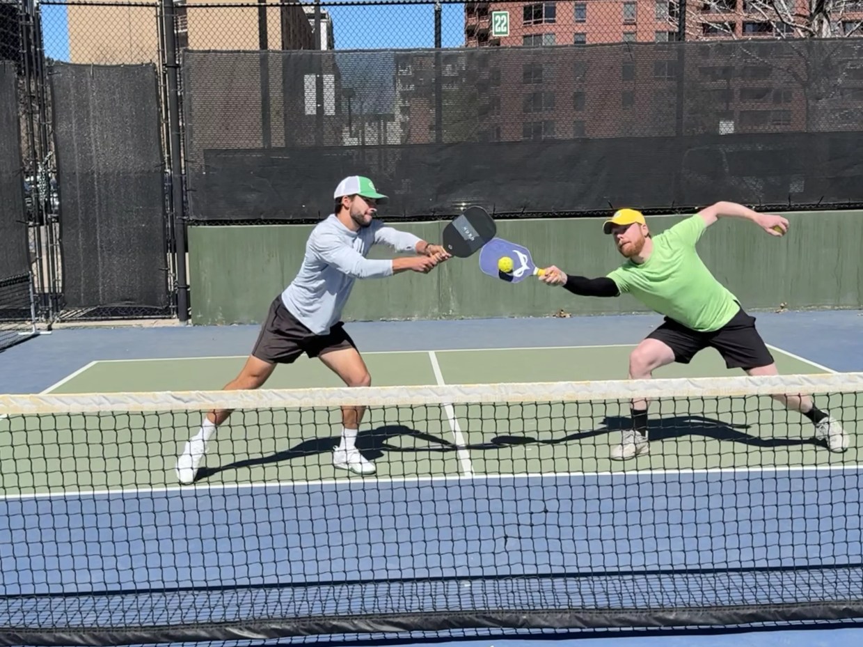 Men play pickleball with cushioned paddles