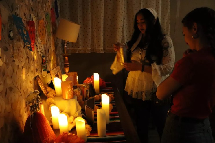 A woman at an ofrenda.