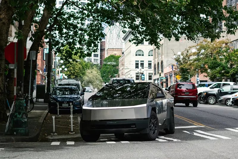Tesla cybertruck under tree