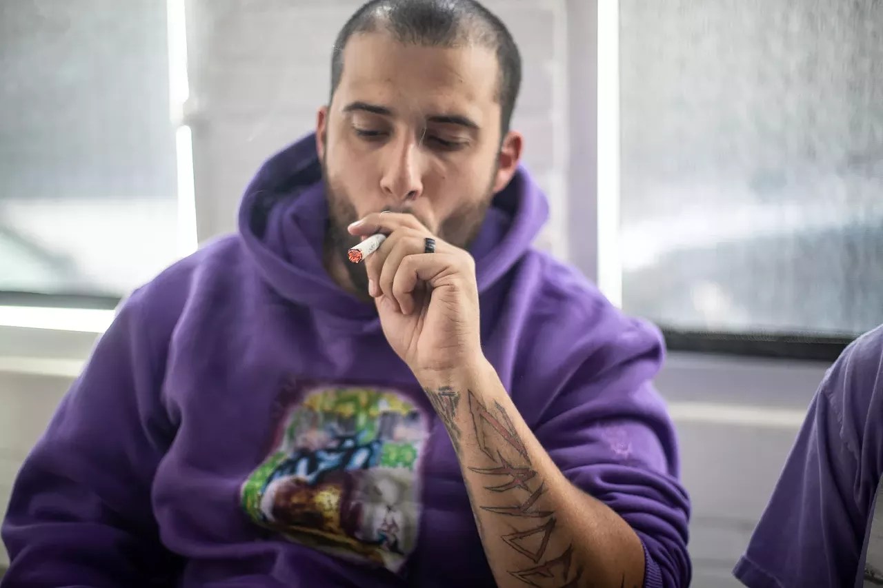 man takes hit off a joint