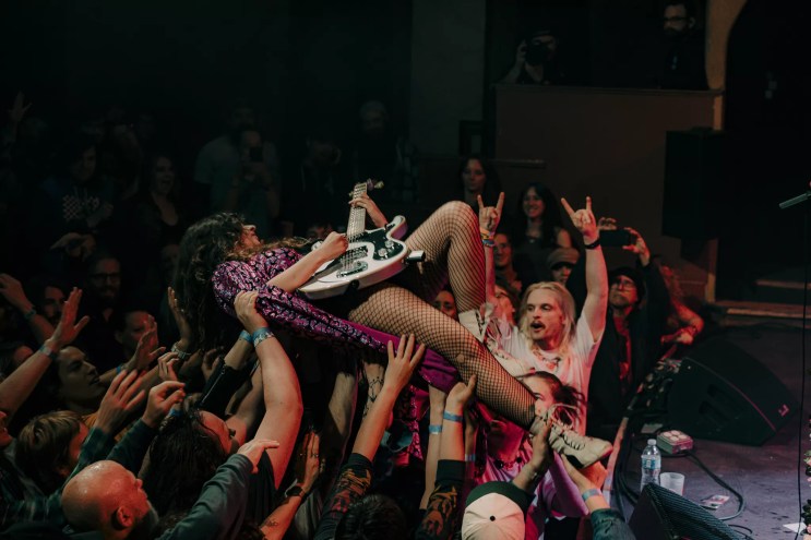 A photo showing Demi Demitro, of the Velveteers, crowd-surfing at the Bluebird Theatre in Denver, Colorado on Friday, April 25, 2025.