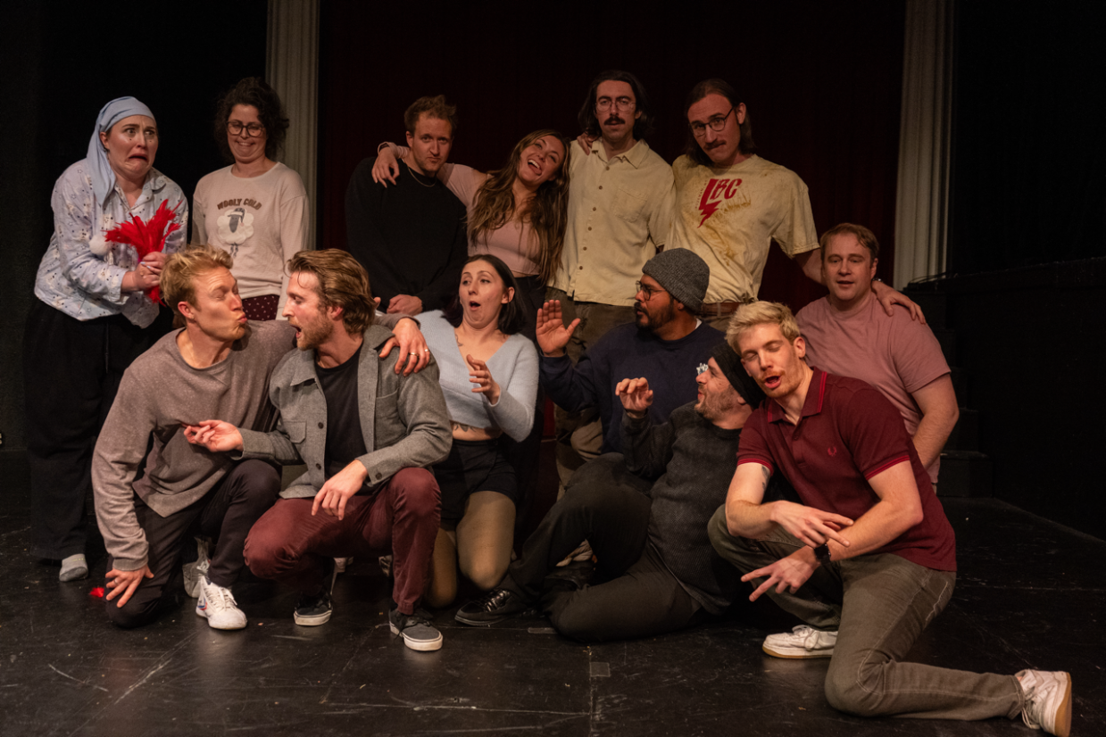 People pose together in a theater.