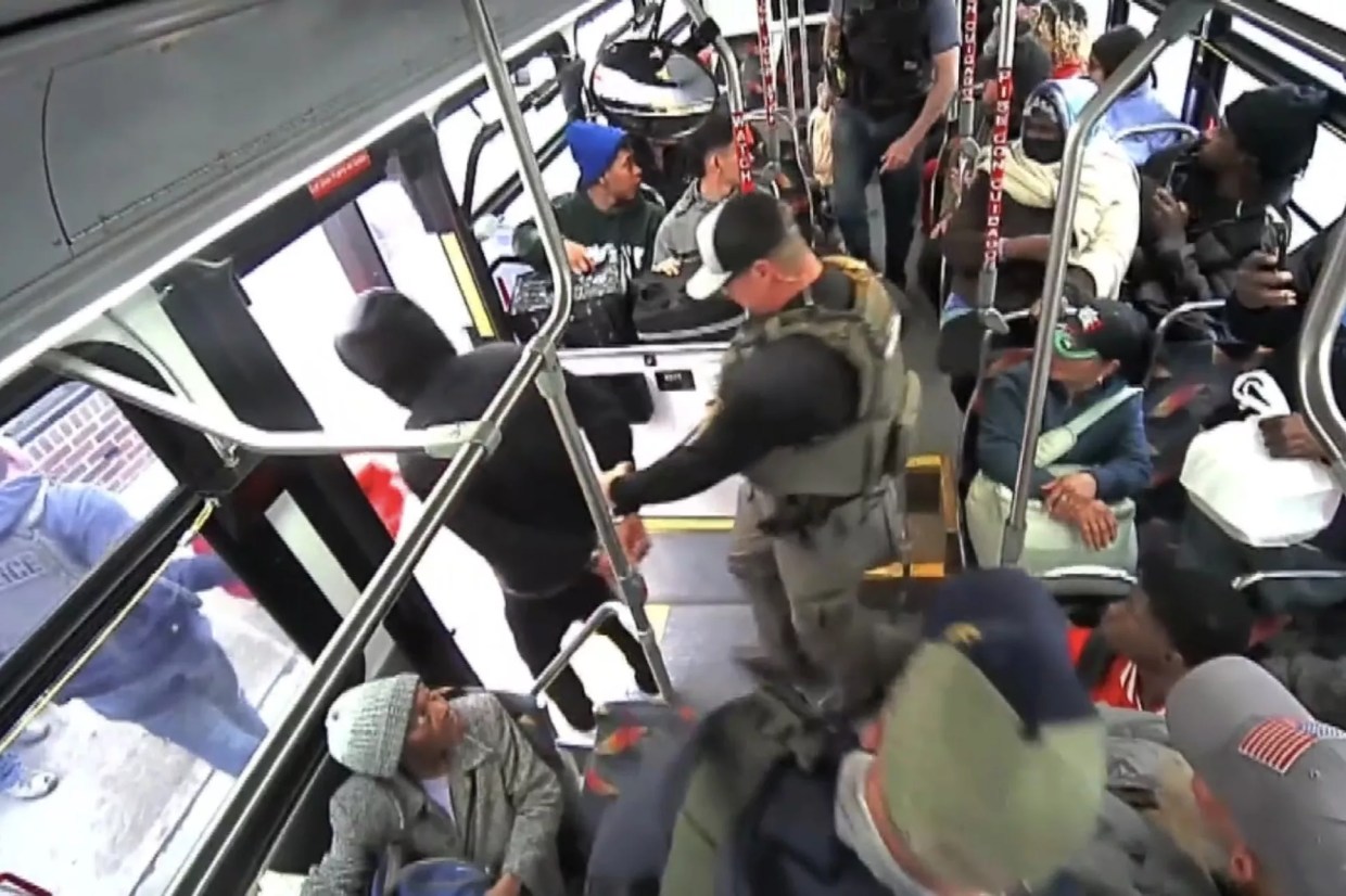 A man is arrested on a bus.