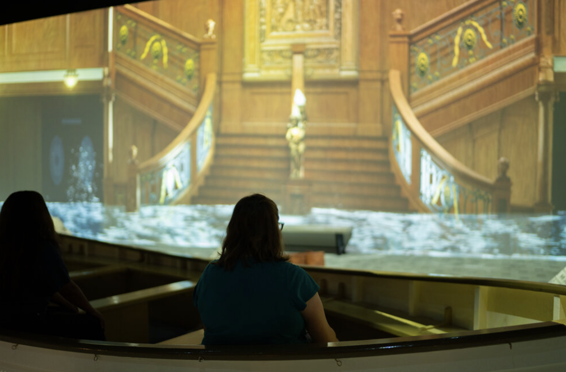 A person watches as water floods the great hall of the Titanic