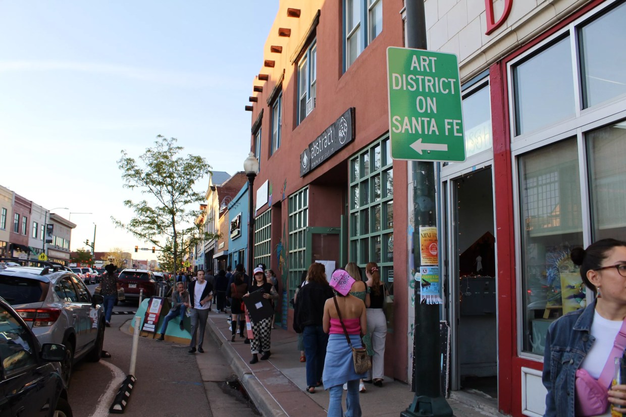 People walk down an avenue