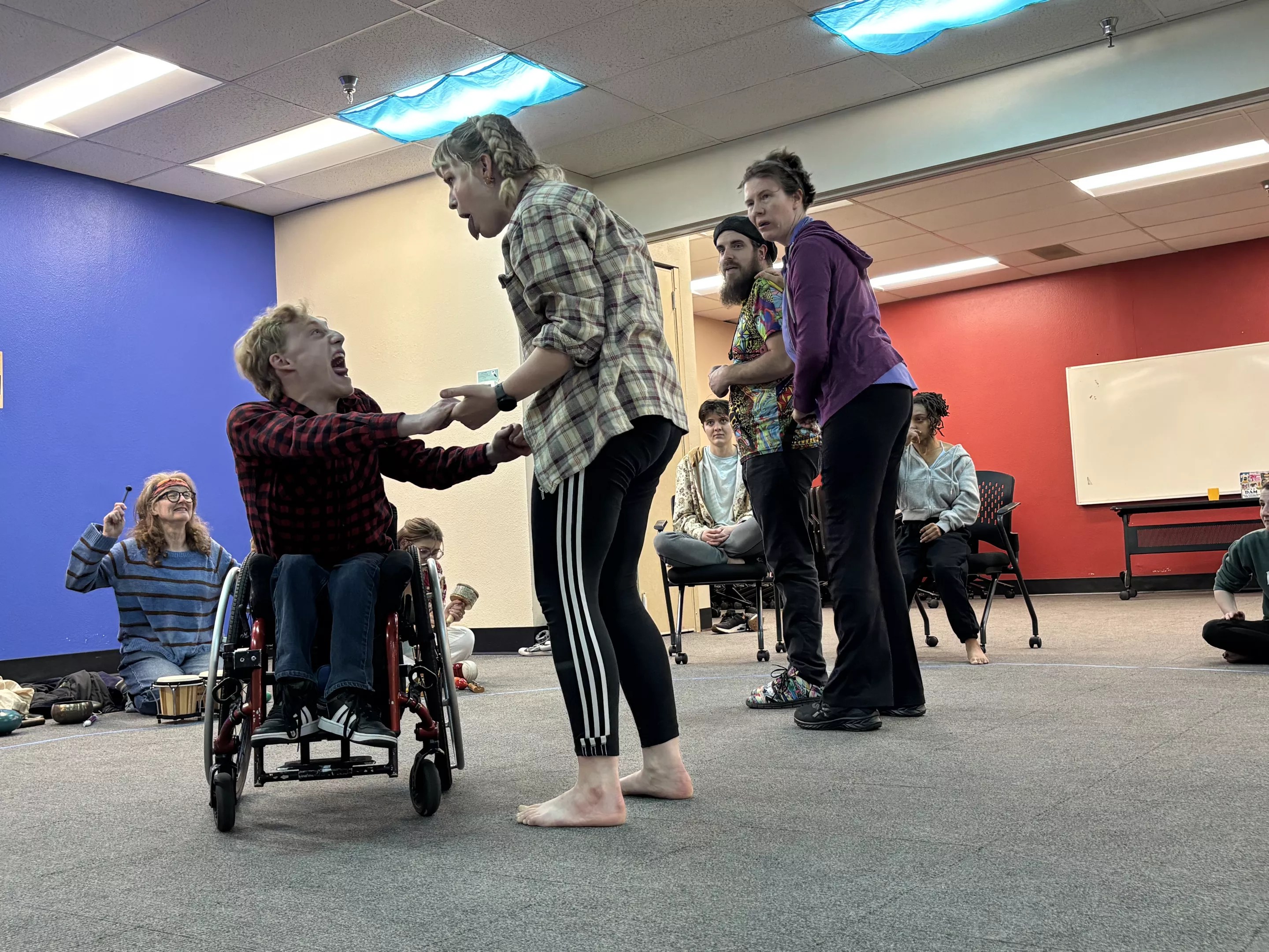Artists with disabilities practice a play.