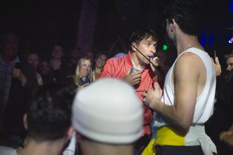 A vocalist sings from out in the audience